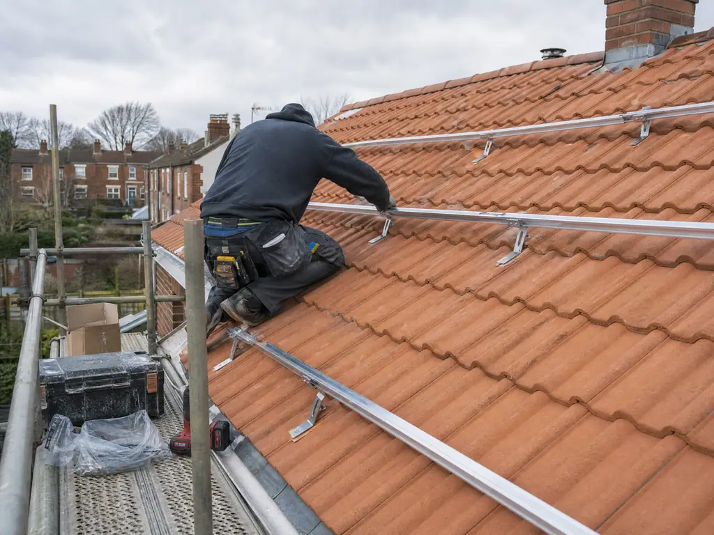 Mounting rails refitted to a new roof before the solar panels go back, Birmingham