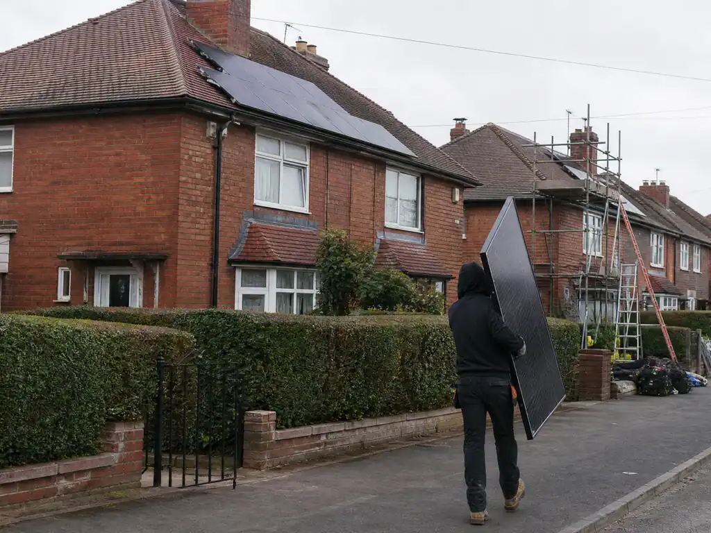 Solar panels on the hipped roof of a 1930s estate house in Walsall